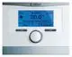 Vaillant Thermostat mit LCD-Display zeigt aktuelle und gewünschte Temperatur sowie Uhrzeit an. Bedienelemente zur Temperatureinstellung und Menüauswahl sind vorhanden.